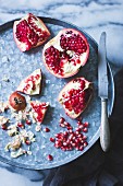 Pomegranate and seeds on a tray