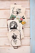 Collection of vintage cards with silhouette motifs in wire rack on wooden wall