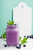 Blueberry smoothie and White ceramic serving board