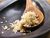 Boiled natural rice on a wooden spoon