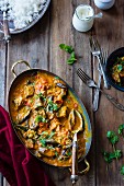 Aubergine curry with coriander in a serving dish