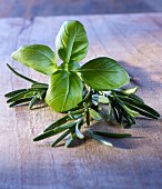 Basil and rosemary on a wooden board