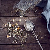 Tea strainer with herbal tea (lemongrass, peppermint, aniseed, ginger, sweet pickle, sunflower, blue mallow blossom)