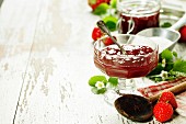 Strawberry jam in a jar on wooden background
