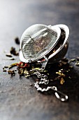 Tea composition with tea strainer on dark background