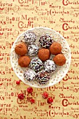 Chocolate truffles with coconut shavings, cocoa powder and sugar beads