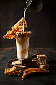 Banana and vanilla milkshake with caramel cream and crunchy decorations