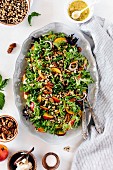 Black-Eyed Pea Salad with Peaches and Pecans in a light gray oval dish on a white background