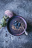 Blueberry acai banana smoothie bowl topped with bluberries, sesame seeds and cacao nibs