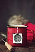 Enamel mug with festive tea bag tag