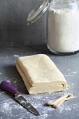 Homemade puff pastry dough on a floured surface