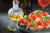 Italian tomato bruschetta with basil and olive oil on crusty slice of bread