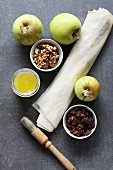 Ingredients for making apple strudel: Apple, raisins, walnuts, filo pastry and butter