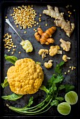 Orange cauliflower and yellow spit peas on pan