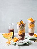 Spices with chocolate sauce, melon and pistachios