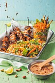 Chicken skewers with peanut sauce and grain salad