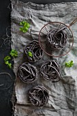 Dark ribbon noodles on a linen cloth