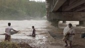 People with nets in flooded river, Philippines