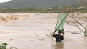 People in flooded river, Philippines