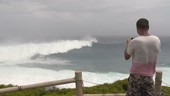 Man watching storm waves, Japan