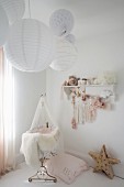 Nostalgisches Babyzimmer mit Papierlampen über der Wiege
