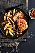 Pork minute steaks with pear and pepper chutney and potato wedges