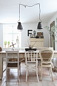 Various white chairs around old wooden table