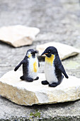 Two hand-made, felted, woollen penguins