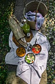 Picnic basket and blanket with artisan bread and vegan dishes