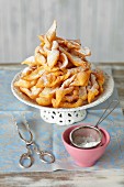Faworki (Polish fried pastries) with icing sugar