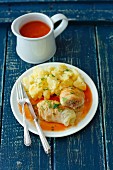 Chinese cabbage leaves stuffed with turkey and barley in tomato sauce with potato pure