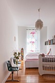 Cot, flamingo-patterned curtains and waiting-room bench in bedroom