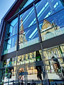 The Mariendom (New Cathedral) reflected in the glass façade of the Hotel am Domplatz in Linz, Austria