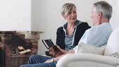 Retired Senior Couple at home with digital tablet