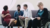 Doctor consulting pregnant patient in hospital waiting room