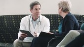 Doctor consulting patient in hospital waiting room