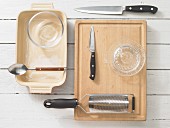 Various kitchen utensils: casserole dish, grater, knife, citrus press