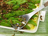 Baked green beans with chillies and hazelnuts
