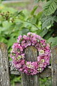Wreath of clover flowers on weathered picket fence