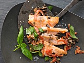 Salmon fillet with tomato, black olives and basil