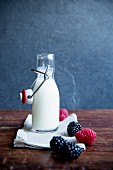 A milk bottle with fresh berries