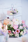 Flower arrangement and petit fours on cake stand