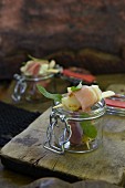Pear and raw ham kebabs in a glass