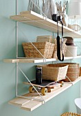 Baskets, skateboard and camera on String shelves