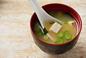 A bowl of miso soup in a traditional Japanese miso bowl