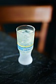 Pernod with ice cubes in a shot glass