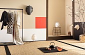 Elegant Japanese room with tatami mats, niche, clothes rail and artworks