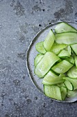 Shaved cucumber strips on a plate
