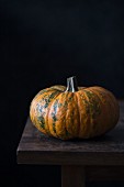 Pumpkin on a dark wooden surface