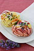 Colourful ribbon noodles with salmon, chives and onions
